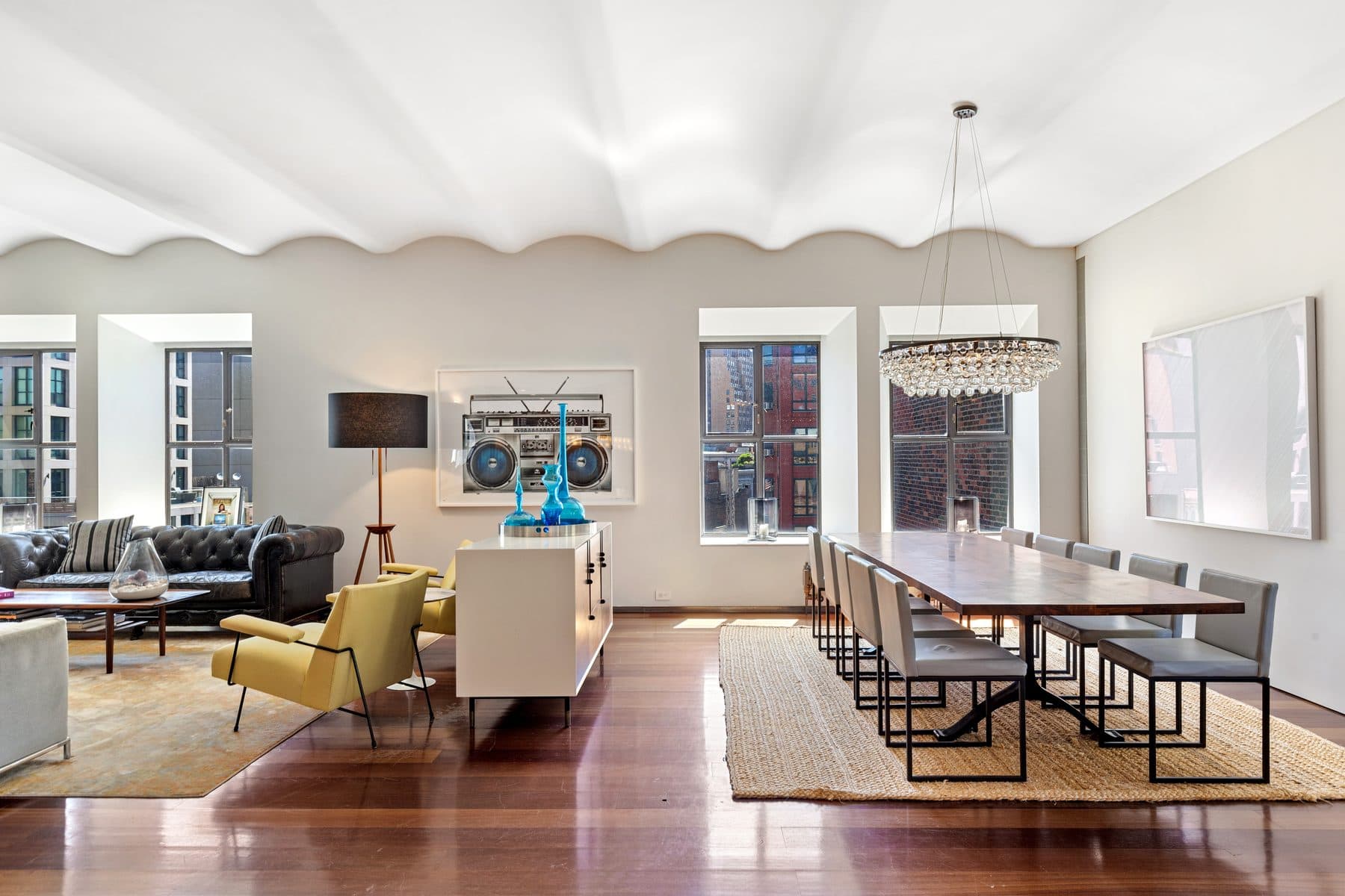 Sunlit Tribeca loft living and dining room with barrel-vaulted ceilings